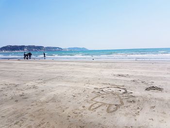 Scenic view of beach against clear sky