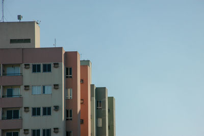 Low angle view of apartment building against clear sky