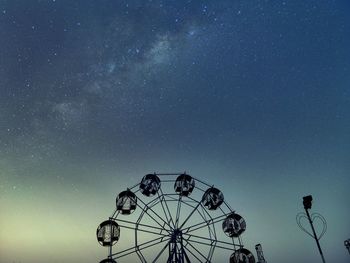 Low angle view of ferris wheel against sky at night