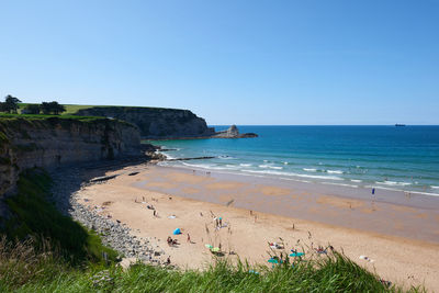 Scenic view of beach against clear sky