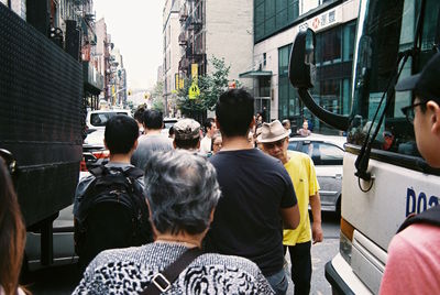 Rear view of people on bus in city