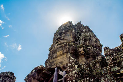 Low angle view of rock formation against sky on sunny day