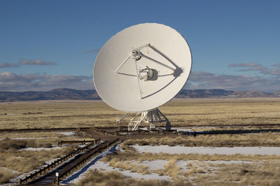 Very large array on field against sky