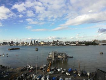 High angle view of sailboats moored in sea against sky