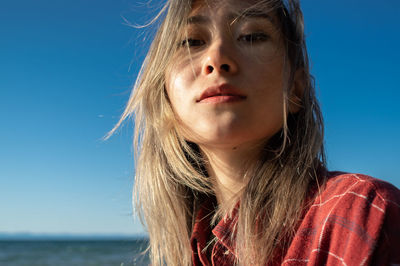Portrait of woman against blue sky