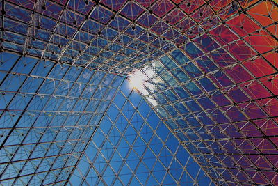 Low angle view of modern building against blue sky