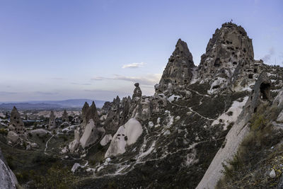 Rock formations on landscape against sky