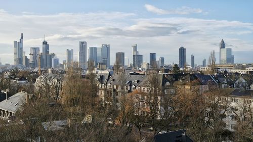 View of cityscape against cloudy sky