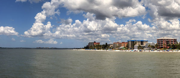 Panoramic view of sea and buildings against sky