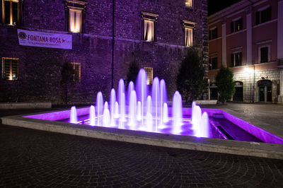 Panoramic shot of illuminated buildings in city at night