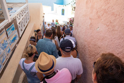 Rear view of people standing on street