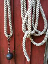 Close-up of rope tied to wooden post