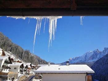 Panoramic view of building and mountains against blue sky