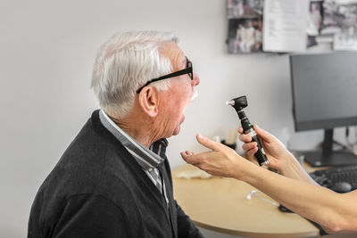 Doctor checking patient's throat