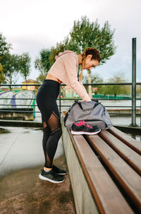 Sportswoman preparing equipment for training outdoor