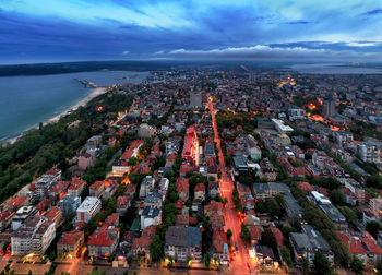 High angle view of townscape by sea against sky