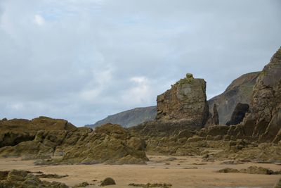 Rock formations on landscape against sky