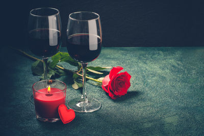 Red rose in glass on table