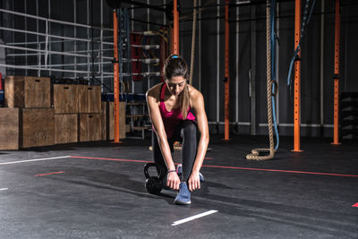 Young woman exercising in gym