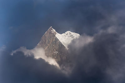 Low angle view of snowcapped mountain against sky