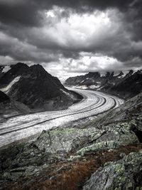 Scenic view of mountains against cloudy sky