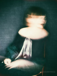 Midsection of woman sitting at home