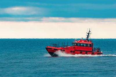 Boat sailing in sea against sky