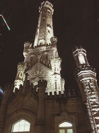 Low angle view of illuminated building at night