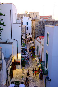 High angle view of people on street amidst buildings in town