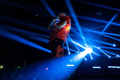 Low angle view of illuminated lighting equipment at night