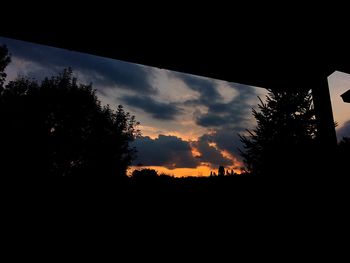 Silhouette trees against sky during sunset