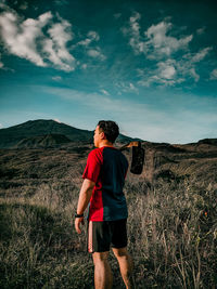 Full length of man standing on land against sky