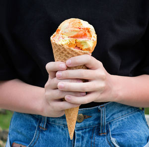 Cropped image of hand holding ice cream