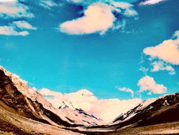 Scenic view of mountains against blue sky