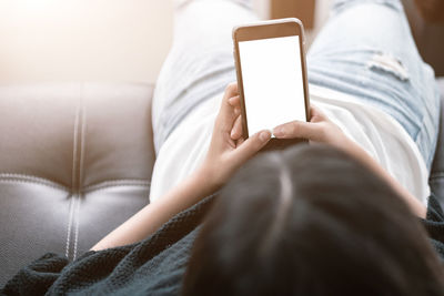 Midsection of man using mobile phone