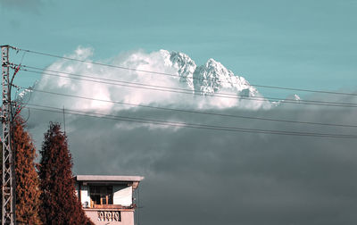 Low angle view of electricity pylon against sky