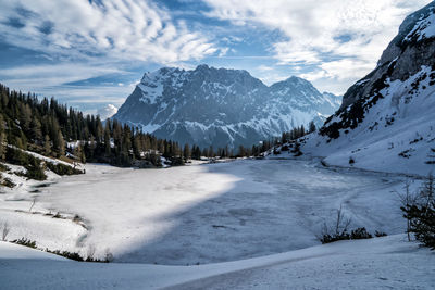 Scenic view of snow covered mountains against sky