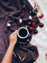 High angle view of woman holding coffee cup