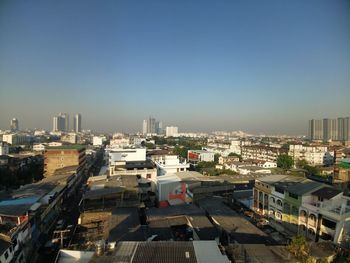 High angle view of buildings in city against clear sky