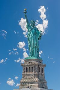 Low angle view of statue against cloudy sky