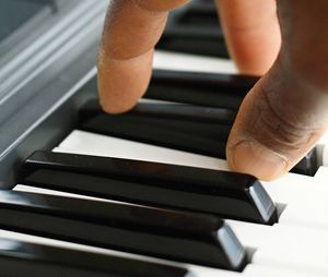 Close-up of hands playing piano