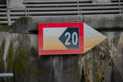 Close-up of warning sign on wooden wall
