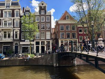 People in front of buildings against sky