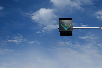 Low angle view of road sign against sky