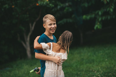 Children splashing water on the lawn