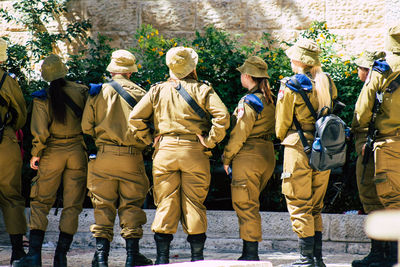 Rear view of soldiers standing outdoors