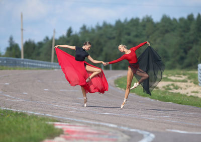 Full length of woman holding umbrella