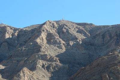 Scenic view of rocky mountains against clear blue sky