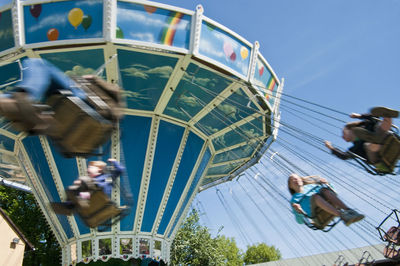 Low angle view of children enjoying in chain swing ride