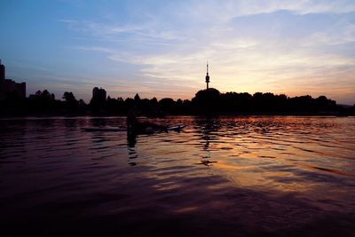 Scenic view of river against cloudy sky